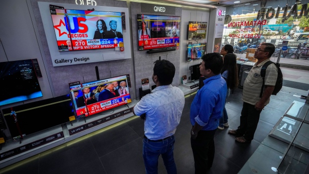 Indian people watch results of U.S. elections on a television in Guwahati, India, Wednesday, Nov. 6, 2024. (AP Photo/Anupam Nath)