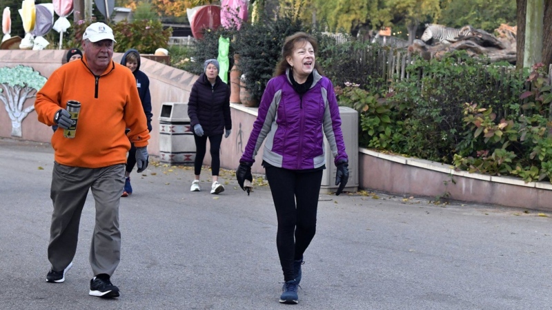 Members of the Get Healthy Walking Club walk the paths past the animal enclosures during the morning at the Louisville Zoo in Louisville, Ky., Friday, Oct. 18, 2024. (AP Photo/Timothy D. Easley)