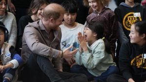 Marjorie Yuan, centre right, reacts as she talks with Prince Harry, the Duke of Sussex, after he participated in a sitting volleyball adaptive sport lesson with students from Shaughnessy Elementary School, during an event to launch the Invictus Games school program in Vancouver, on Monday, November 18, 2024. (THE CANADIAN PRESS/Darryl Dyck)