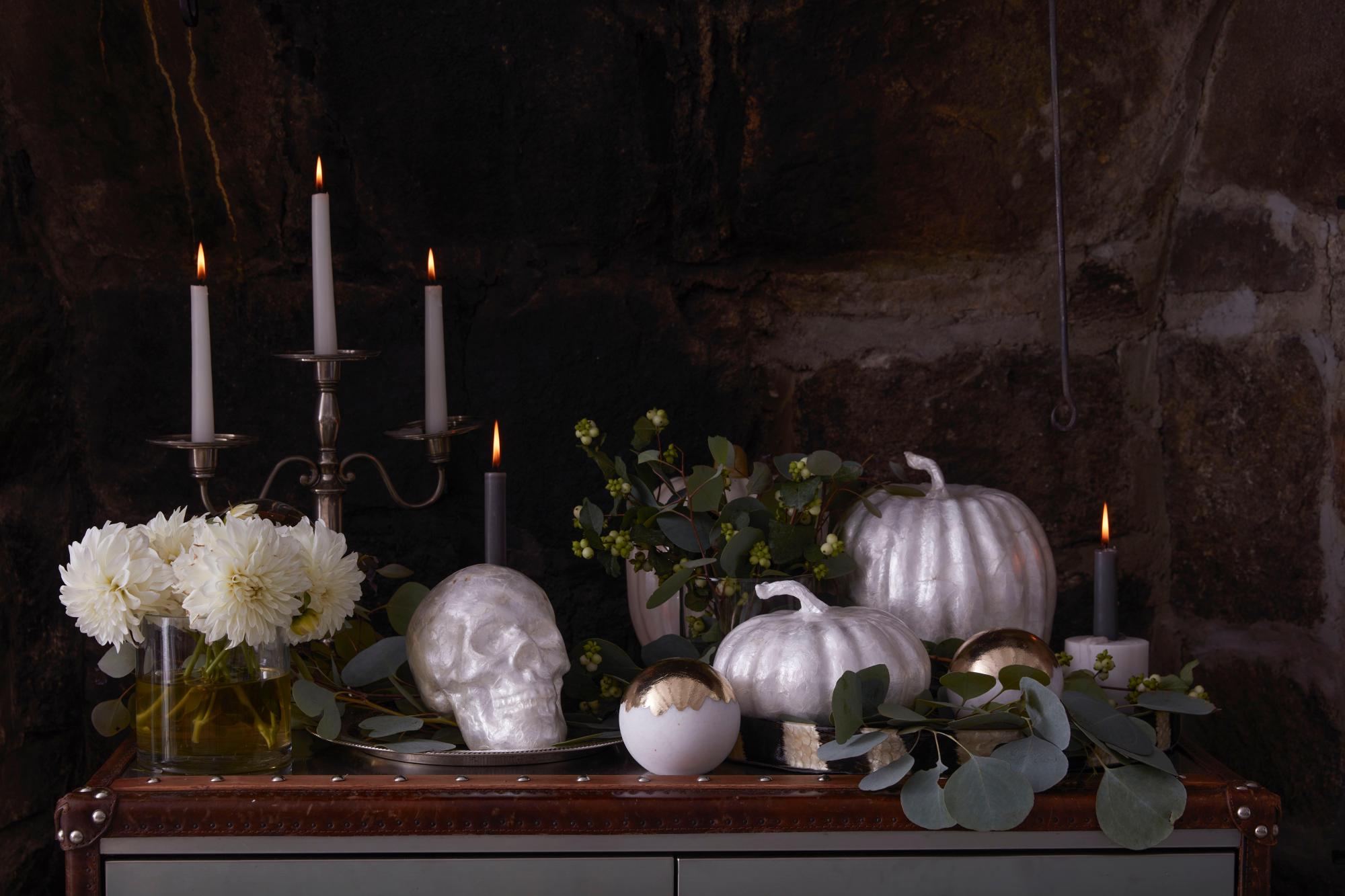 A white Capiz skull and pumpkins handmade using pearl shells