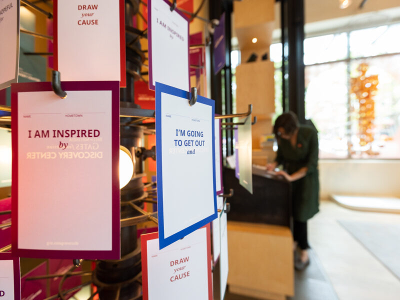 Close up of the share your cause rack in the Discovery Center. Visitors can personalize a card and hang on the rack during their visit.