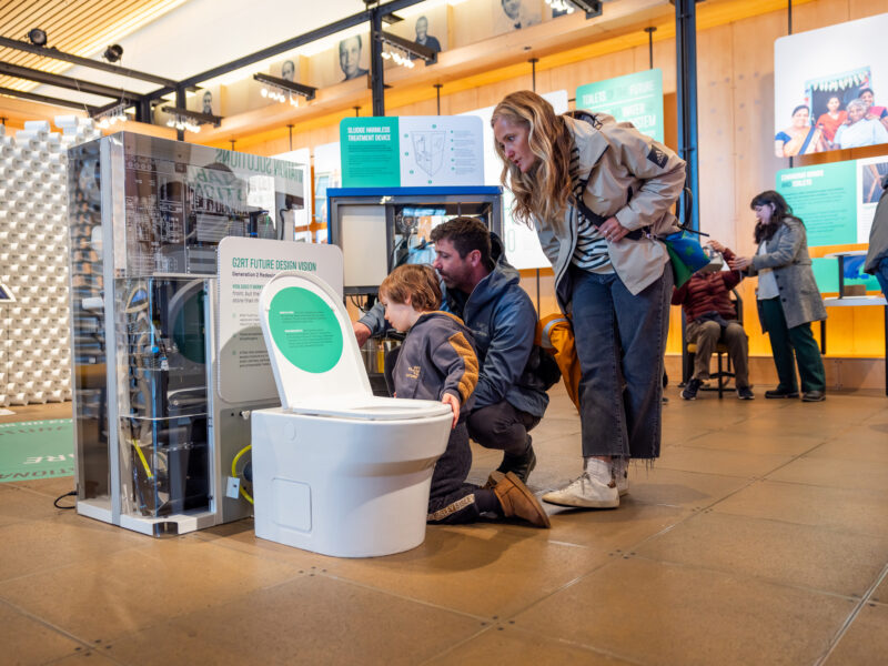 Family looking at a future toilet prototype at the Discovery Center.