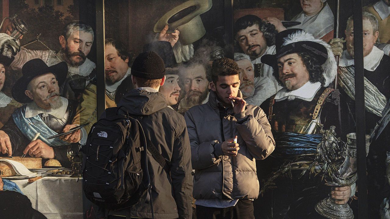 Boys smoke cannabis on Museum Square in Amsterdam