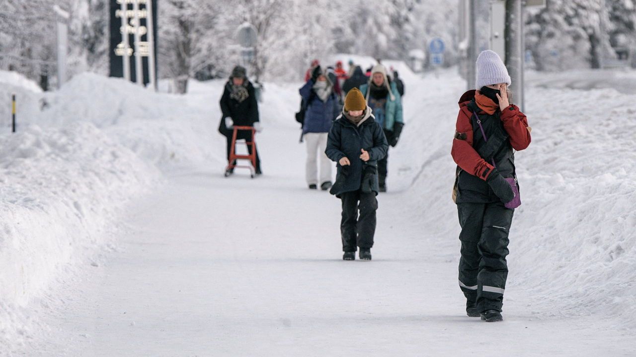 Children walk in snow in Finland