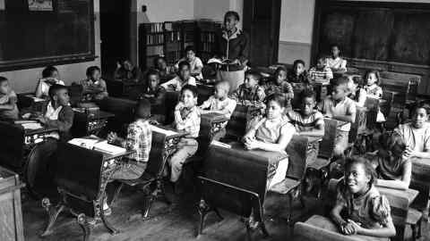Nine-year-old African-American student Linda Brown (first desk in second row from right) sits with her classmates at the racially segregated Monroe Elementary School, Topeka, Kansas, in 1953