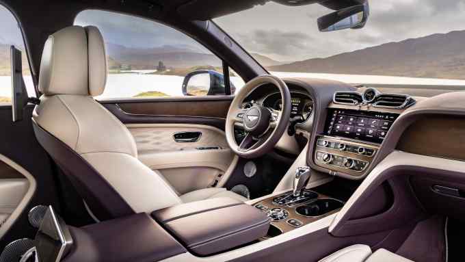 Car interior showing driver’s seat, steering wheel and dashboard