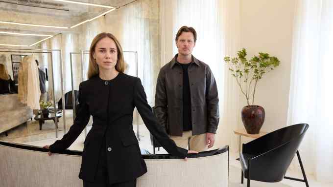 Elin Kling and Karl Lindman in Toteme’s Stockholm headquarters. Kling wears Toteme wool collarless cinched jacket, £740, and wool straight tailored trousers, £390