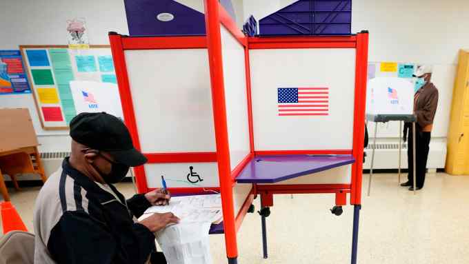 People fill out ballots during early voting at Westside Skill Center in Baltimore in 2022