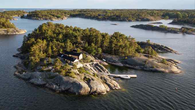 Aerial view of small forested islands with wooden cabins