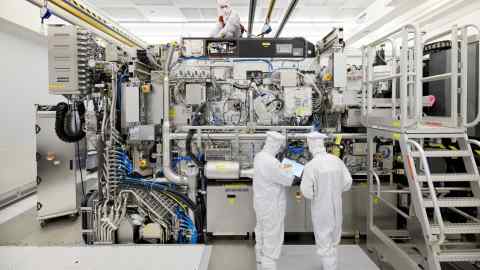 Workers in white overalls at the ASML plant