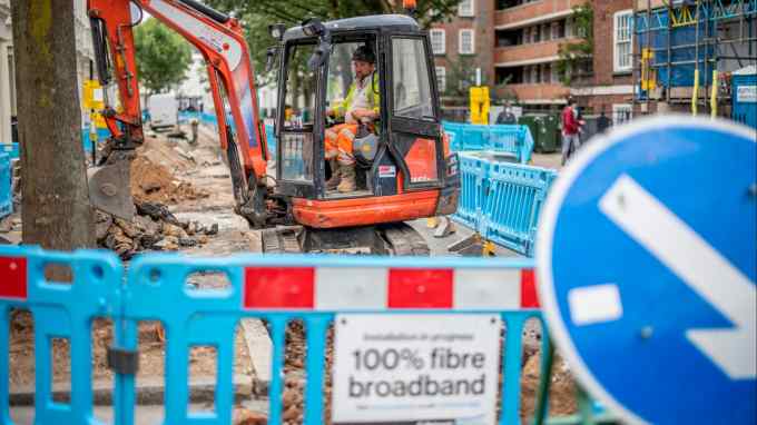 Workers prepare the ground to lay full-fibre cables in Pimlico, London