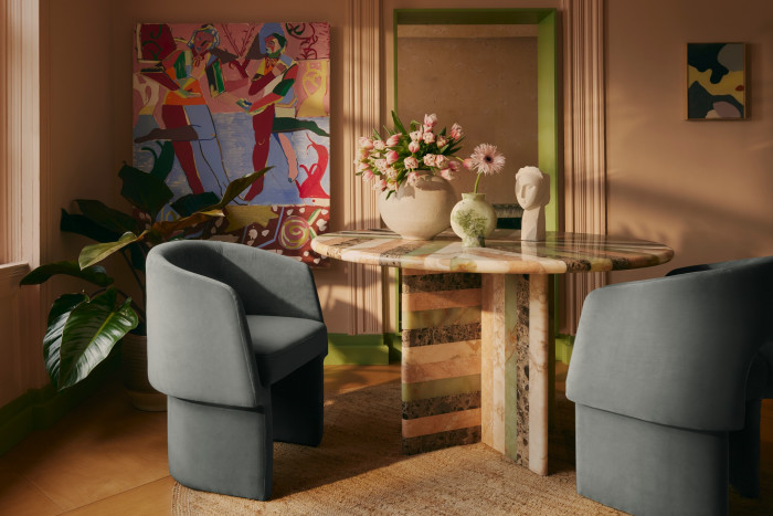 A shot of zingy colour highlights the doorway in this dining space furnished with pieces from Soho Home. The hue echoes the green onyx vein in the Charli table (£5,995) that mixes marbles and terrazzo finishes. Morrell dining chairs (grey, blue), £795, and an Arta rug, £650, are also shown