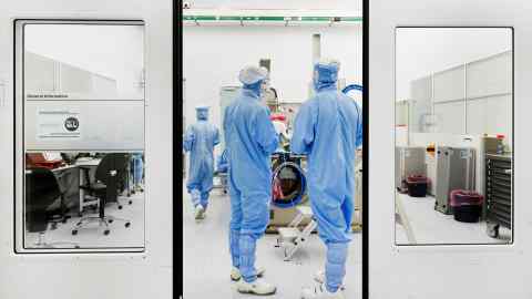 Assembly workers at an ASML lithography system