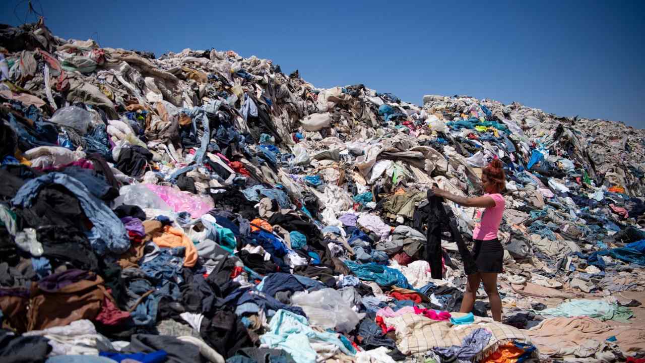 Women search for used clothes amid tons discarded in the Atacama desert