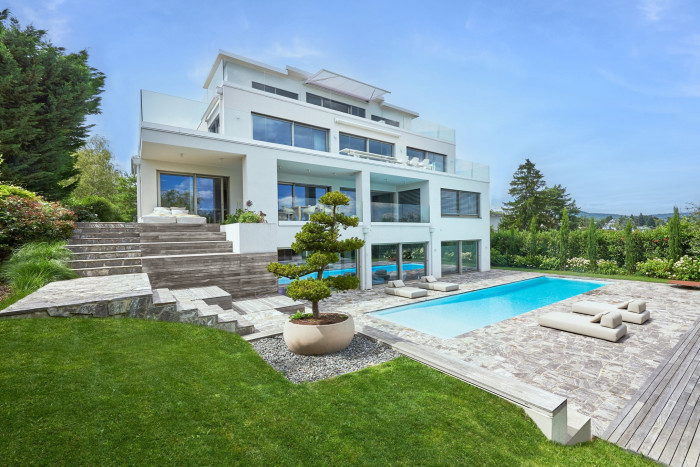 modernist house with pool and lawns