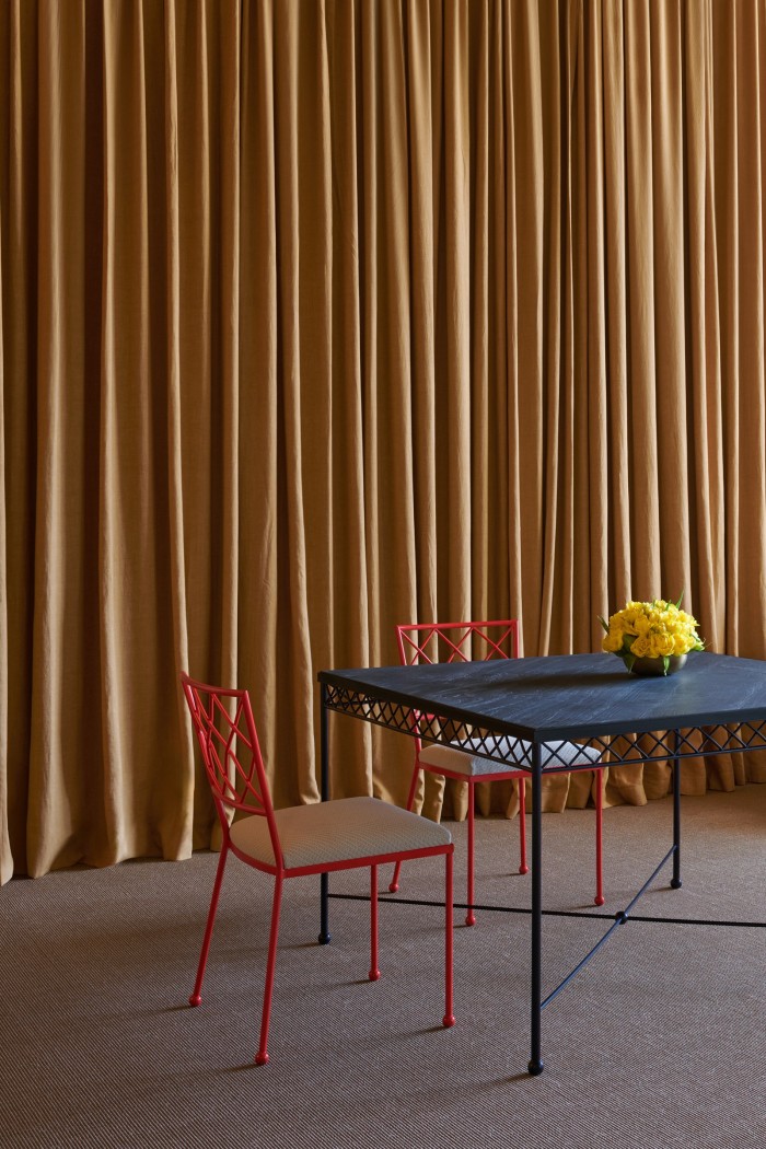 Decadent draping enriches this bright interiorscape by Dimorestudio and Maison Royère. Royère’s square, slate-topped Croisillon dining table is teamed with Croisillon chairs that lend an unexpected pop of red (all POA)