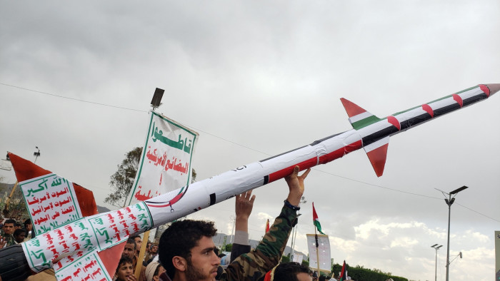 A Houthi supporter holds up a mock missile during a protest against the US and Israel, and in solidarity with the Palestinians in Yemen