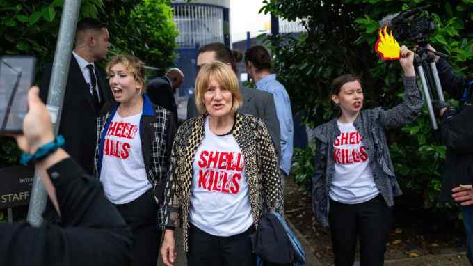 Environmental protesters wearing shirts that say ‘Shell kills’ during the Shell annual meeting