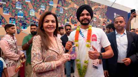 Nita Ambani greets Indian shooter and bronze medallist Sarabjot Singh at India House in Paris