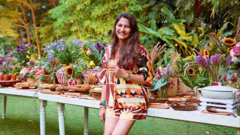 Aditi Dugar in front of the buffet feast laid in her grandparents’ garden