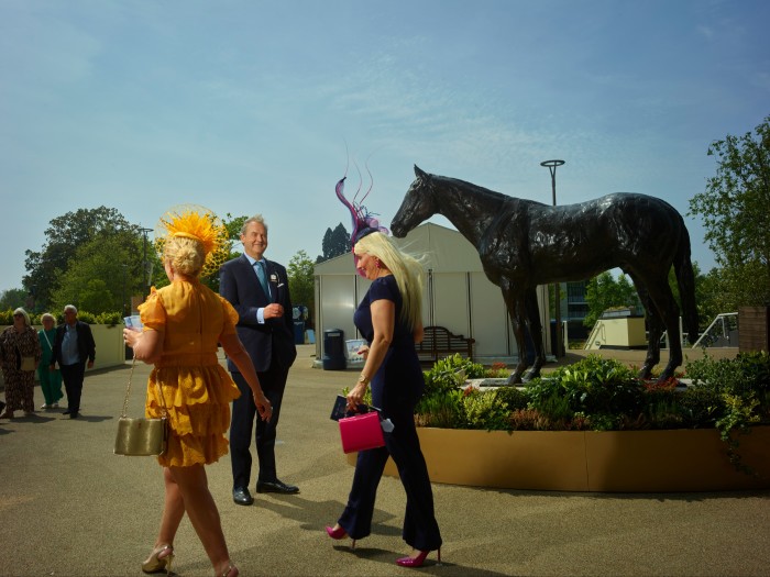 Harry Herbert, founder and chair of Highclere Thoroughbred Racing, with racegoers by the statue of Frankel