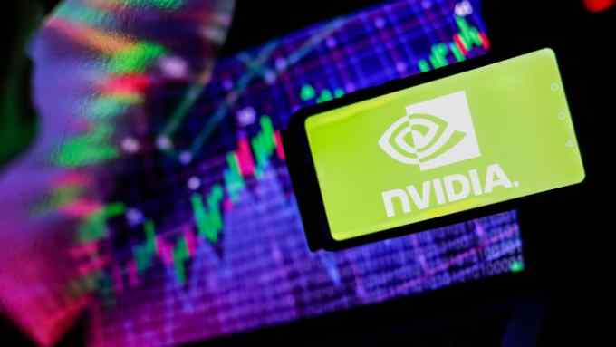 NVidia logo is seen on a smartphone with stock market percentages in the background