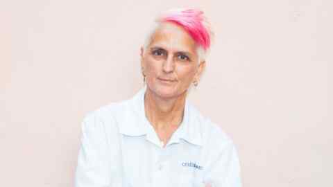 Chef Cristina Bowerman: woman in a chef’s white shirt with dyed pink and peroxide short hair