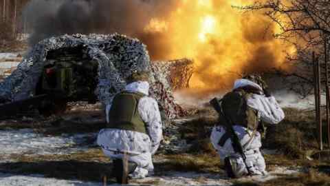 Ukrainian soldiers fire a cannon