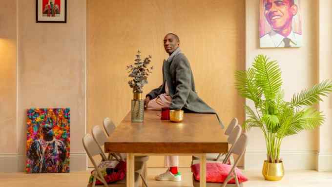 Walé Adeyemi in his north London home. Behind him are artworks depicting (clockwise from bottom left) Biggie Smalls, Muhammad Ali and Barack Obama, the latter by artist Benjamin Wachenje