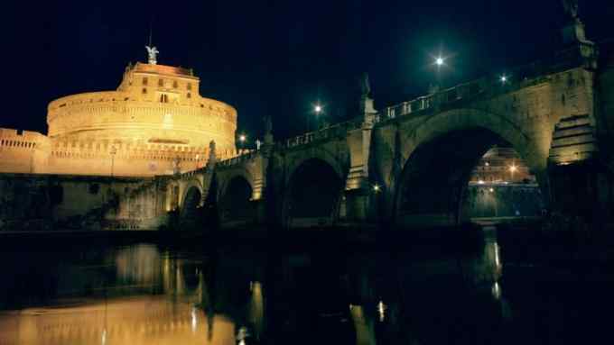 Sant’Angelo Castle and Bridge, Rome, illuminated at night, with their lights reflected in the river