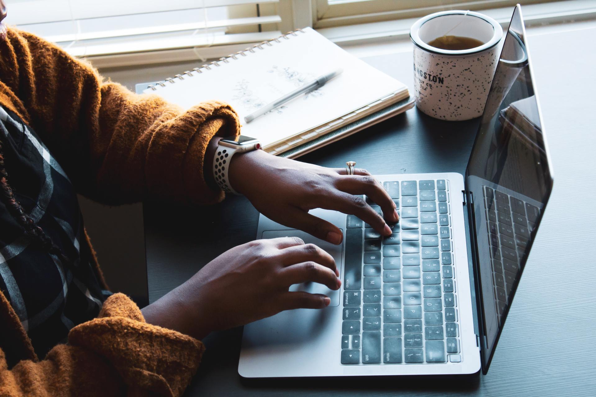 A person typing on a laptop