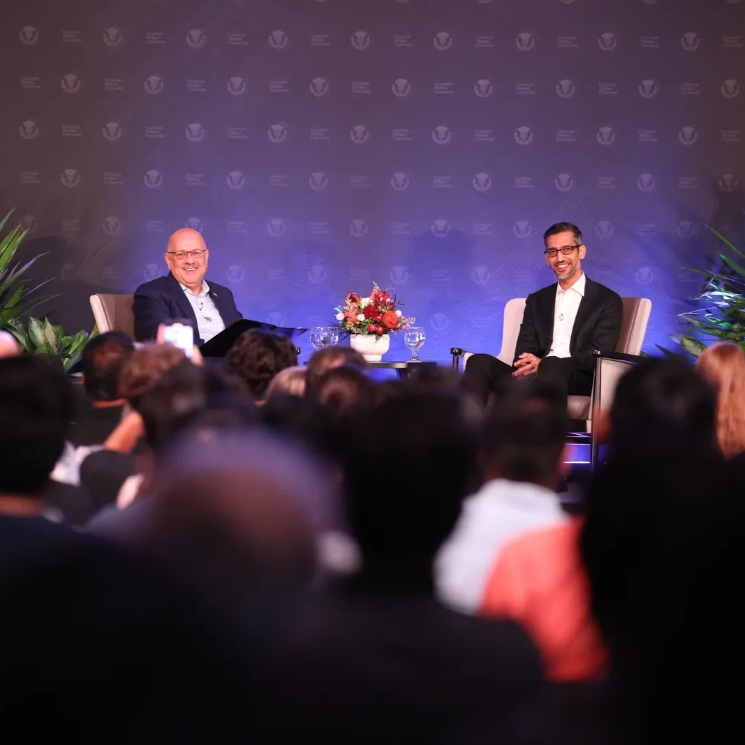 A photograph of the Google CEO being interviewed on a conference stage