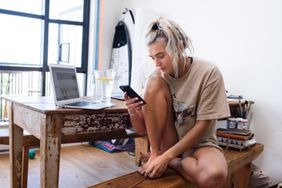 woman looking at phone inside home