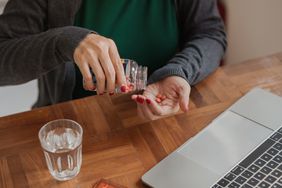 Woman pouring over-the-counter medication into her hand.