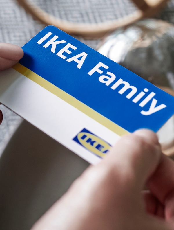 A pair of hands holding the IKEA Family card