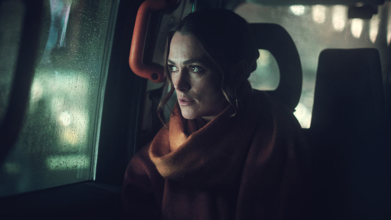 Keira Knightley in 'Black Doves,' a new Netflix series where she plays Helen, shown here sitting in a dark car looking out at the rain