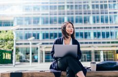 Woman working with laptop outdoors