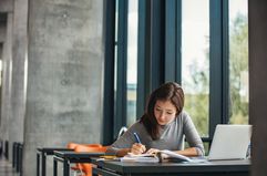 Asian student studying in library