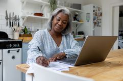 Woman studies at a desk.