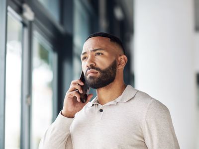 A man talks on a phone.