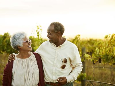 Smiling man talking to female partner in vineyard