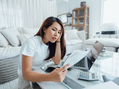 Young woman looking worried going through financials