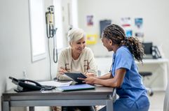 Female doctor sits with a senior patient discussing her Medicare plan