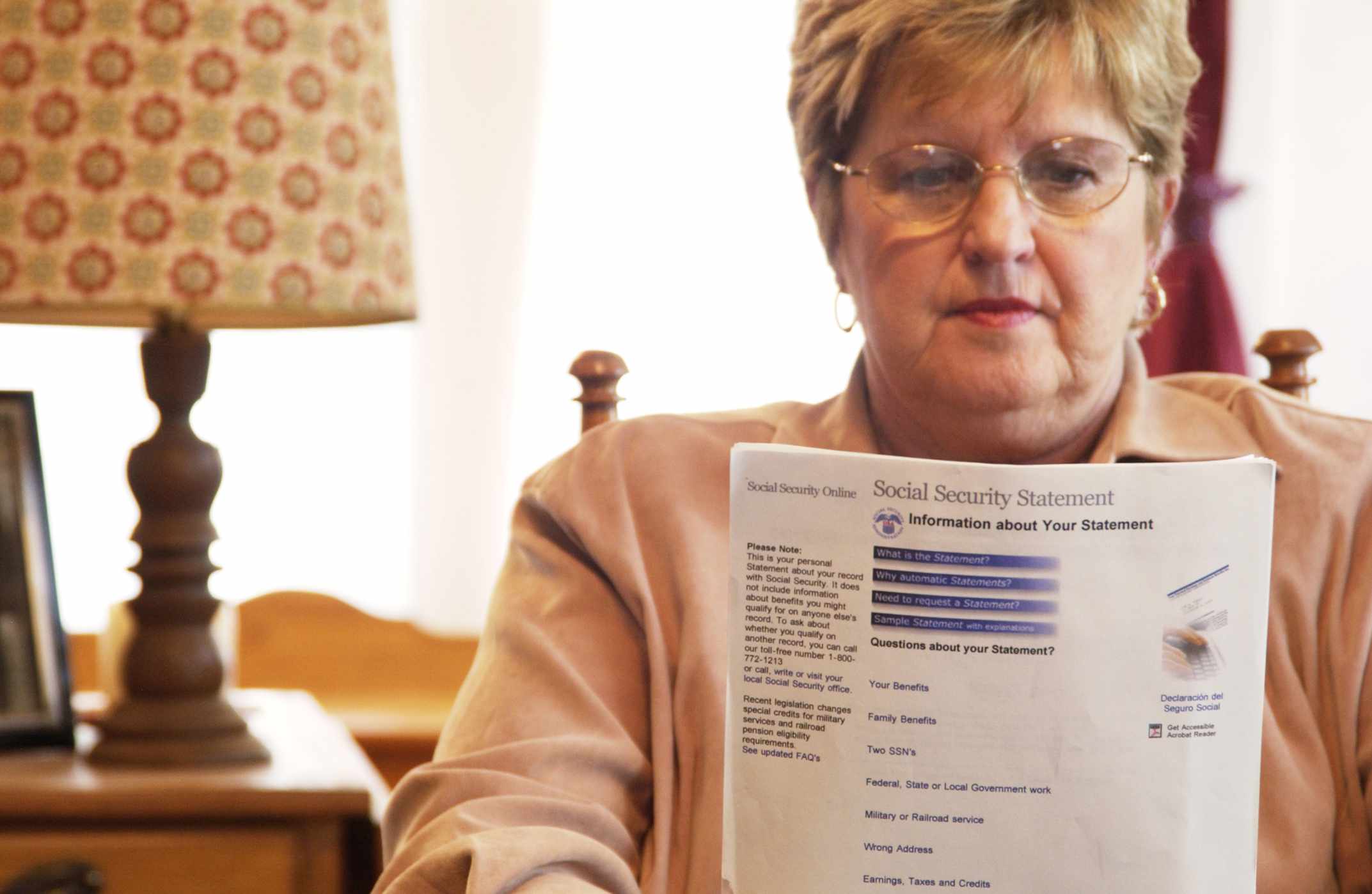 Senior woman reading Social Security form.