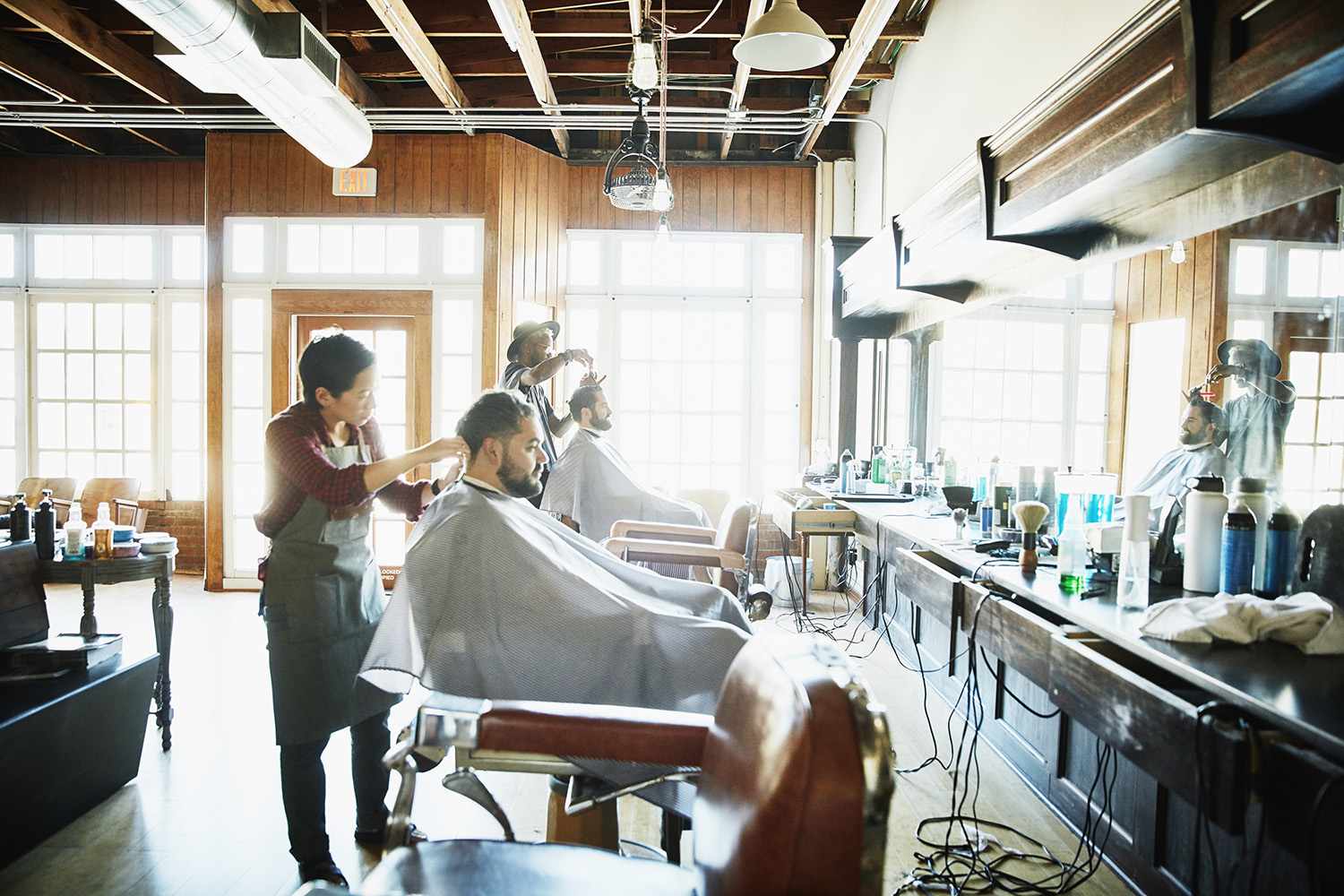 Clients having their hair cut in barber shop