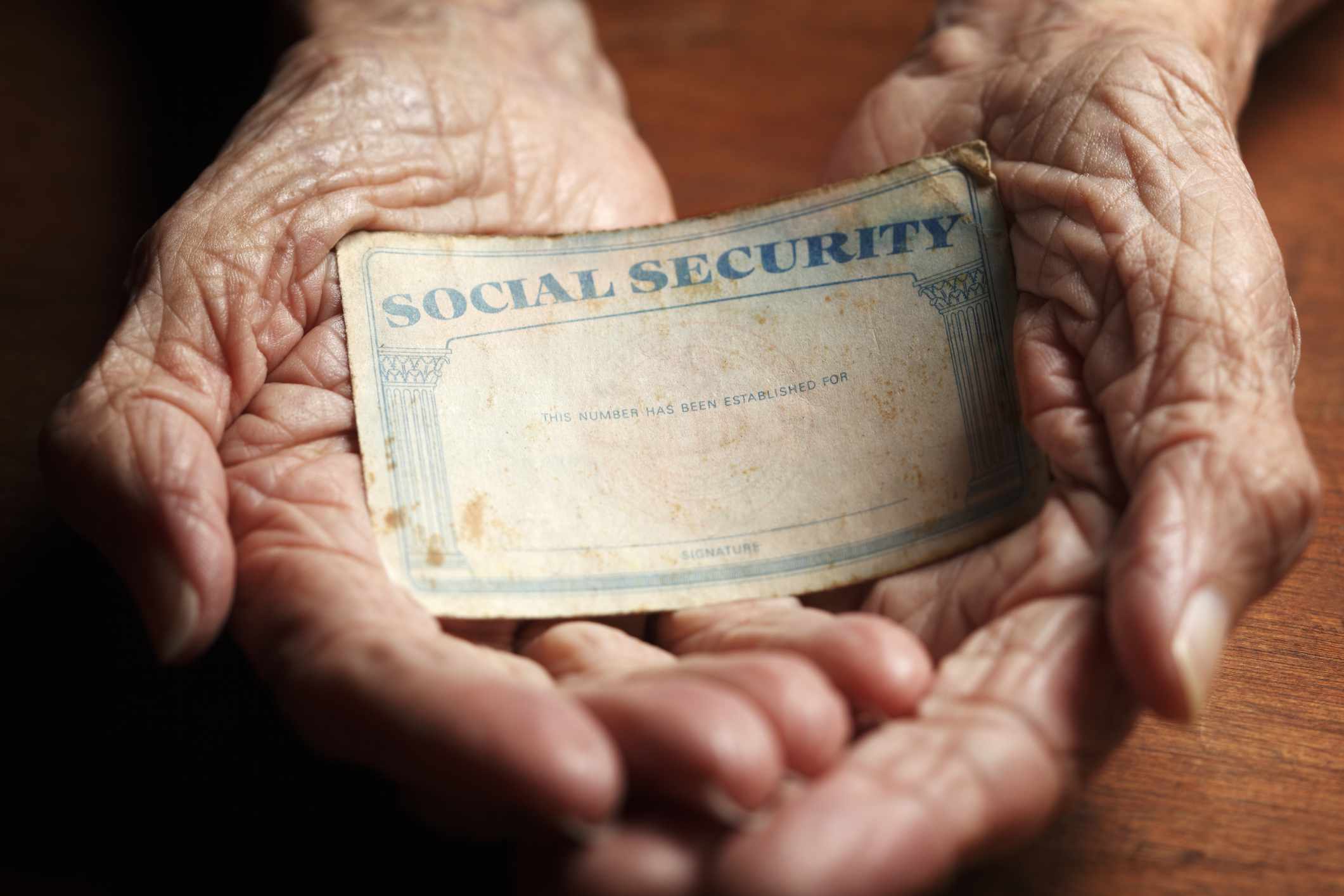 Hands holding Social Security card.