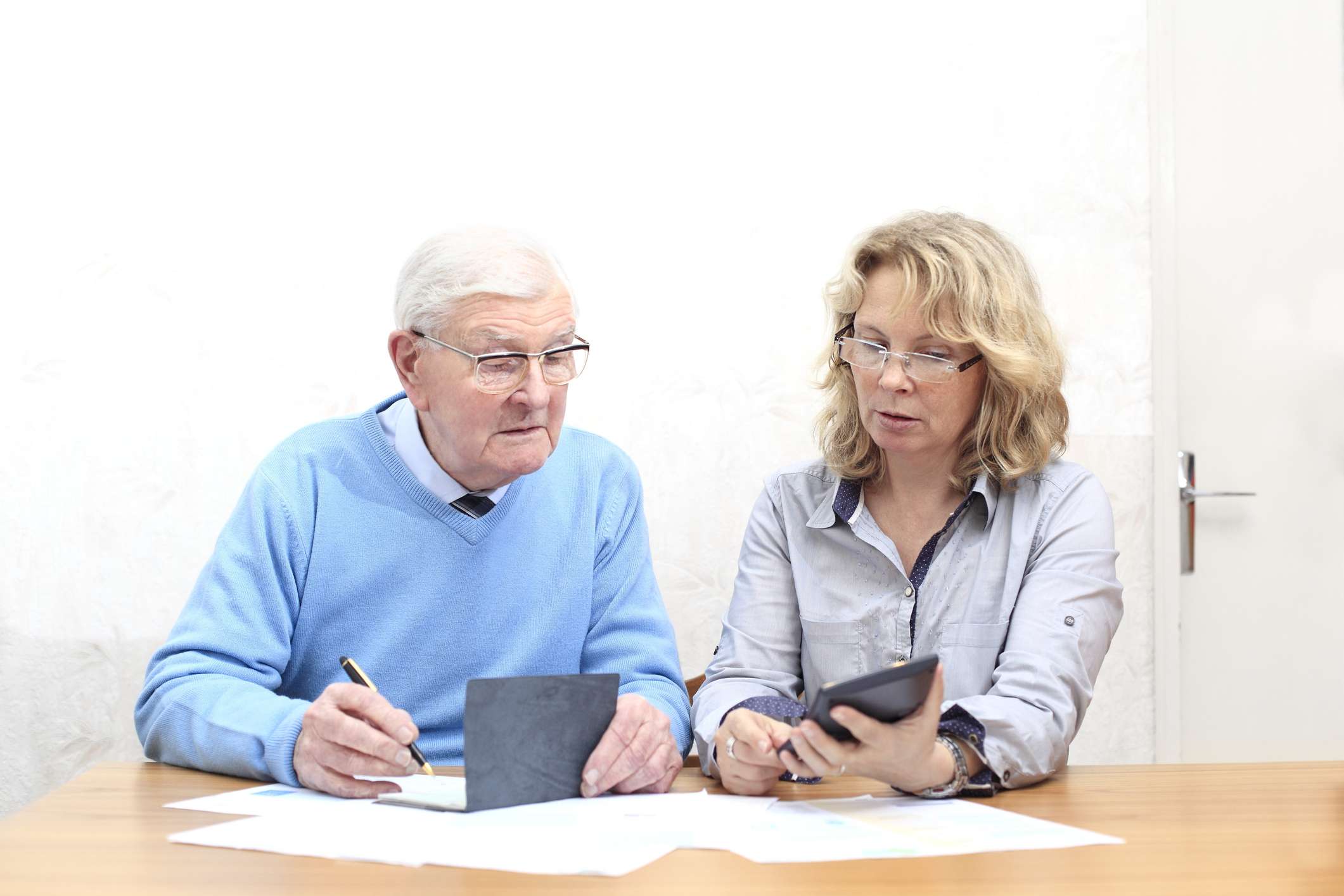 A Daughter helping her father with documents.