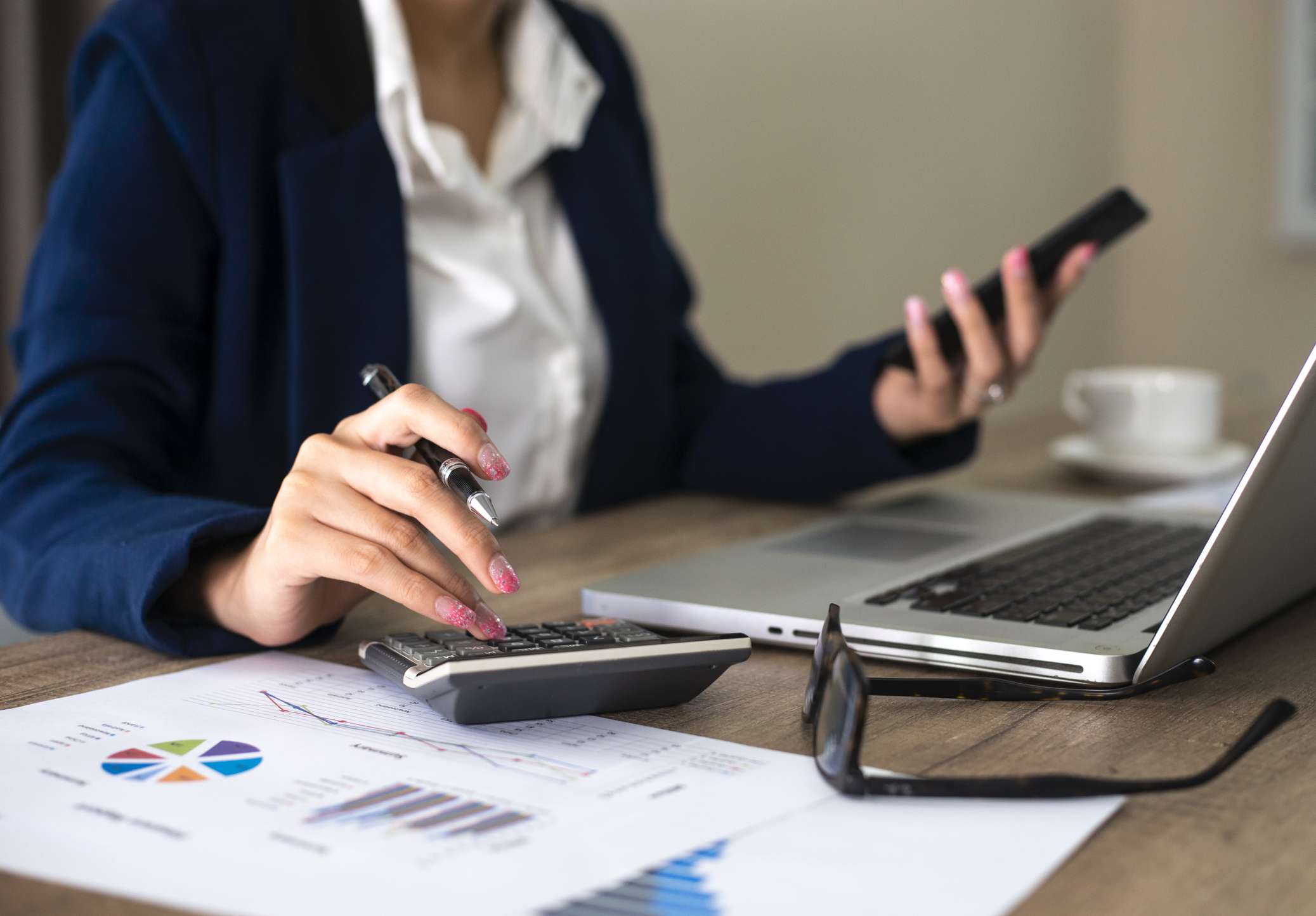 Close up of female accountant or banker making calculations