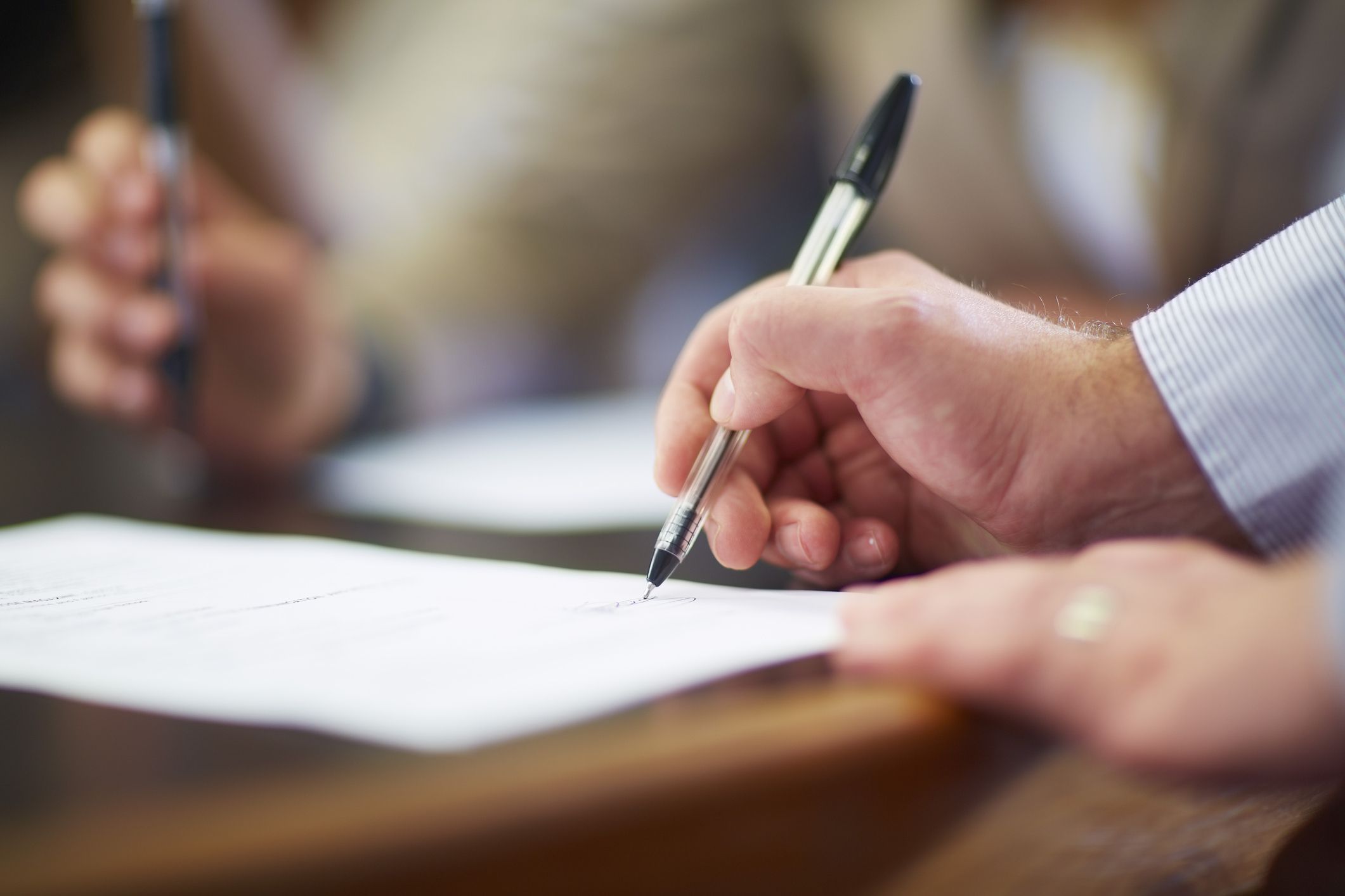 Businessman signing document in boardroom