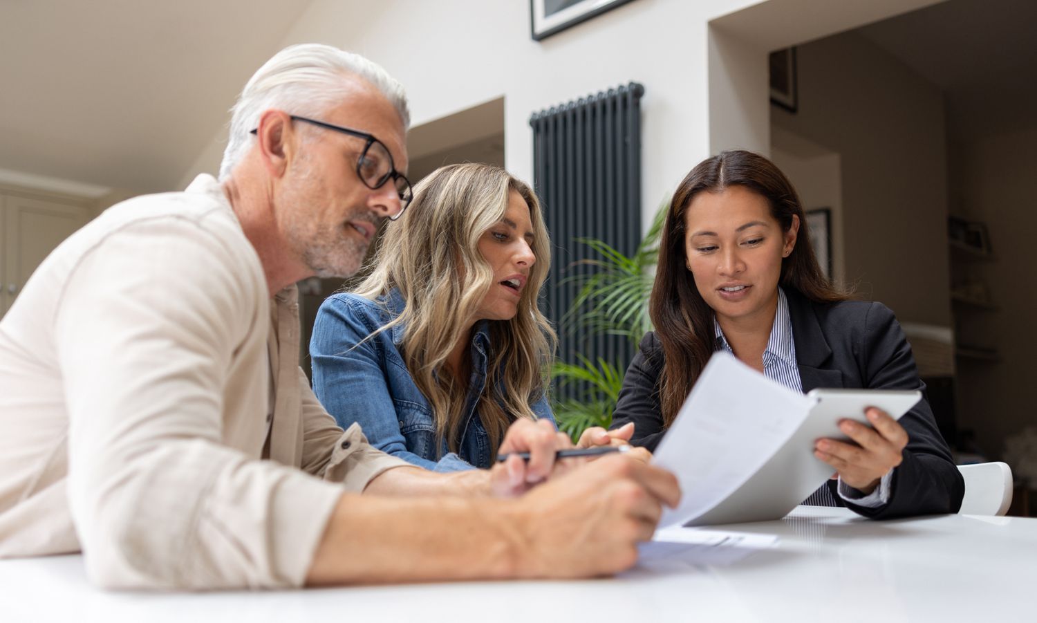 Two investors meeting with a financial advisor and discussing the time horizon of their investments.